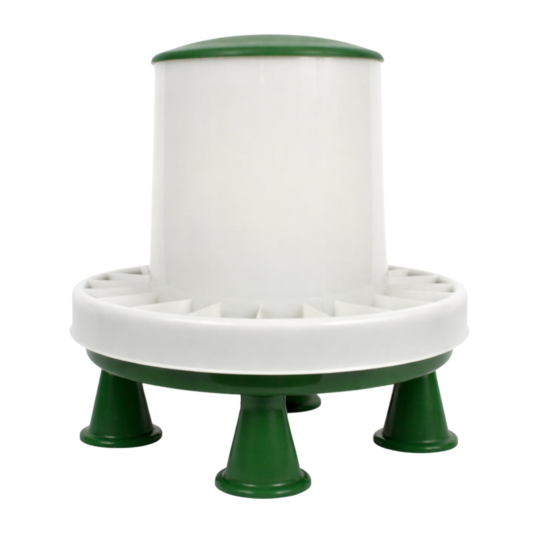 A white and green plastic cylindrical feeder or dispenser with a wide circular base, four short legs, and a ring of small openings around the middle, shown on a plain white background.